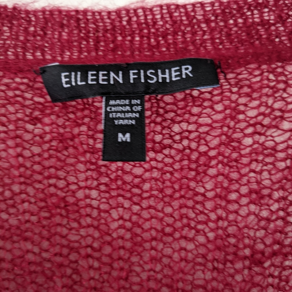 Eileen Fisher! This lovely sweater is soft to the touch and cranberry colored.